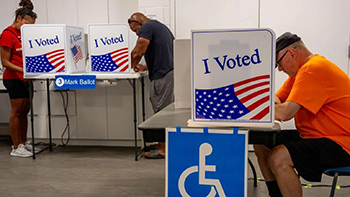 Voter in orange shirt.