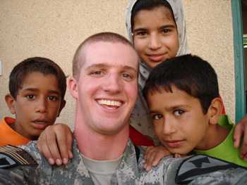 The author with some Iraqi children at a clinic receiving free medical care.